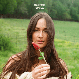 Album cover of a woman with long brown hair in a grassy field holding a flower